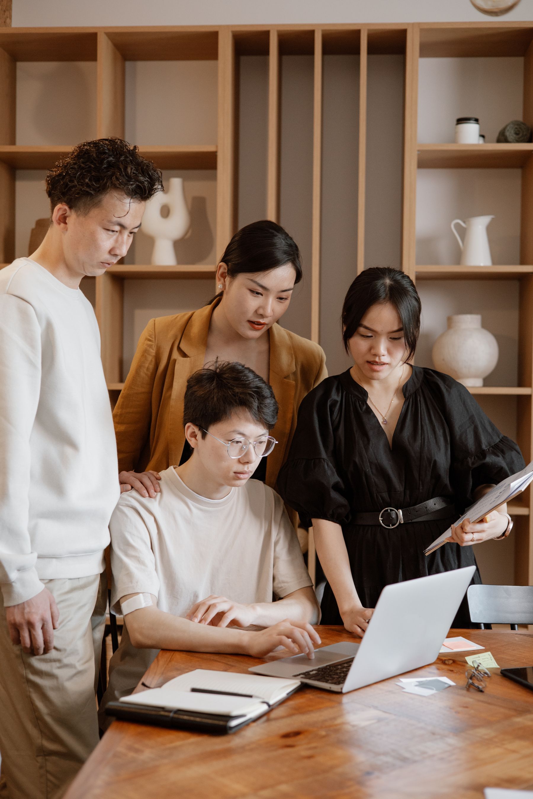 Asian product team reviewing documents together